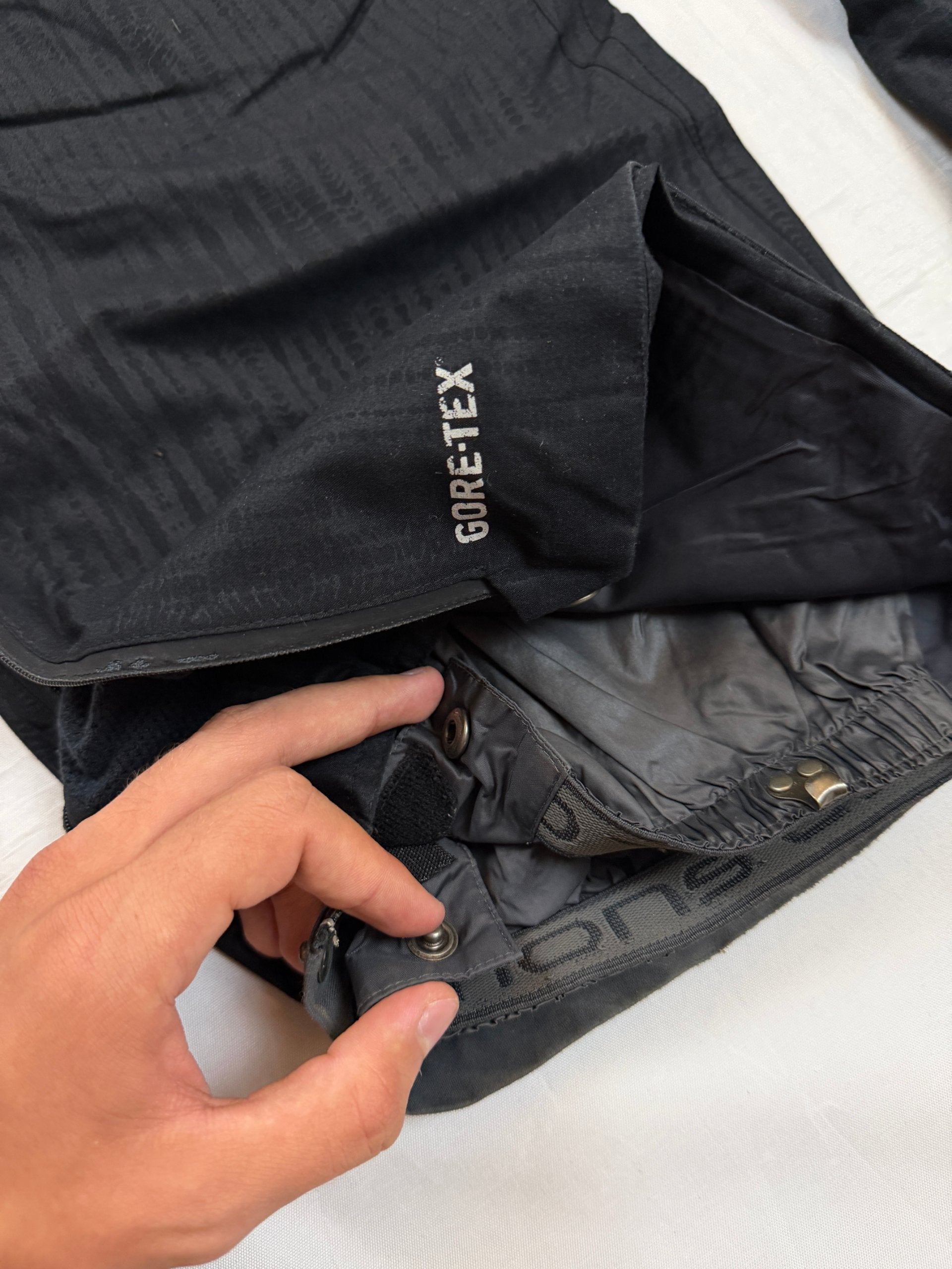 Nike black snow pants with ACG and Gore-Tex logos, adjustable waist, zippered vents.