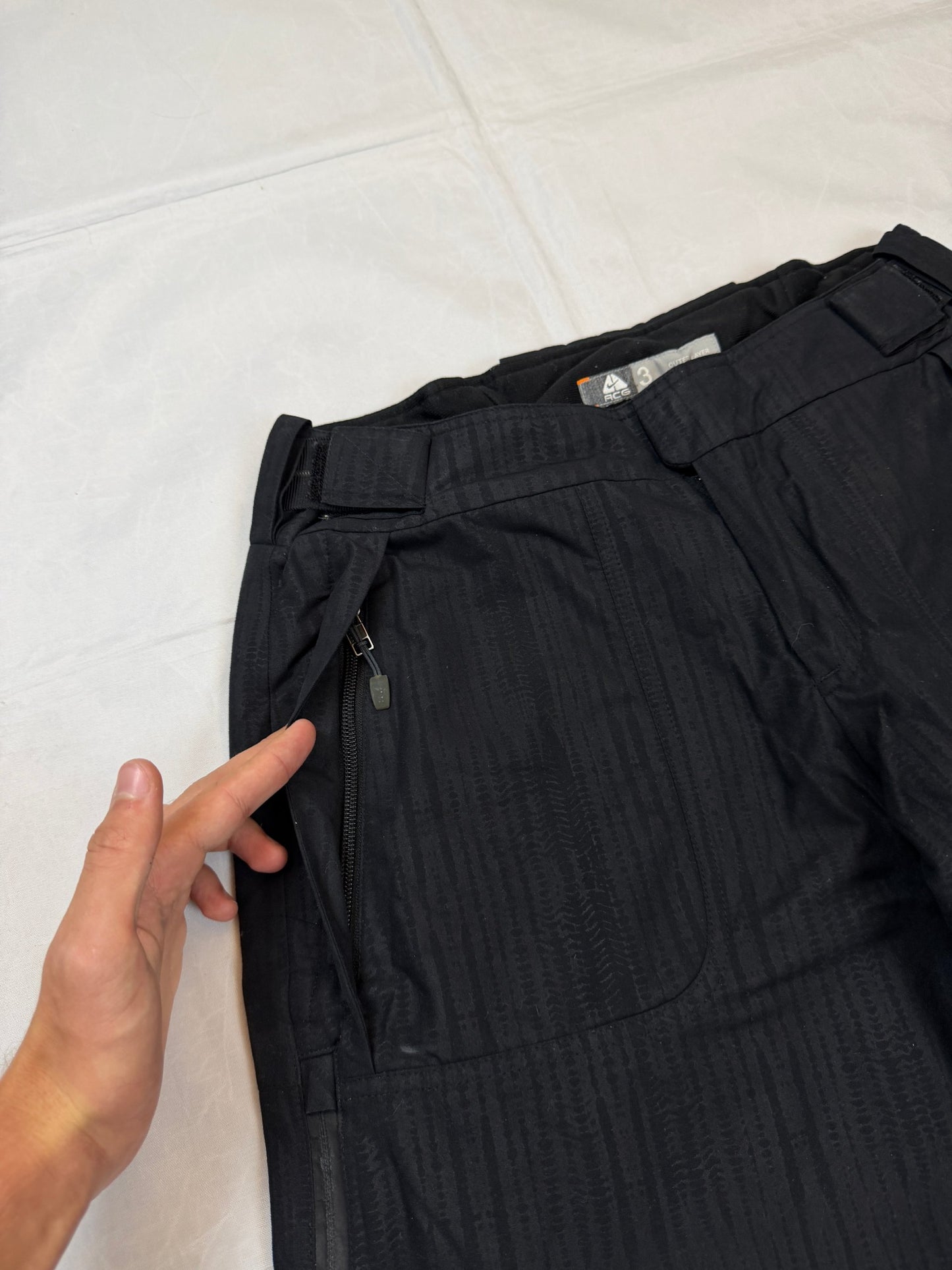 Nike black snow pants with ACG and Gore-Tex logos, adjustable waist, zippered vents.