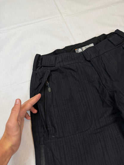 Nike black snow pants with ACG and Gore-Tex logos, adjustable waist, zippered vents.
