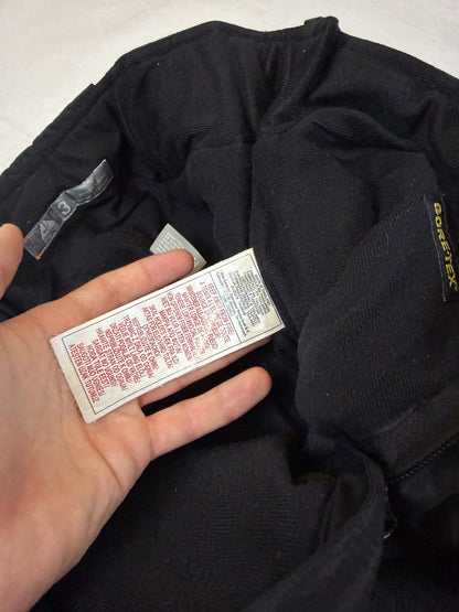 Nike black snow pants with ACG and Gore-Tex logos, adjustable waist, zippered vents.