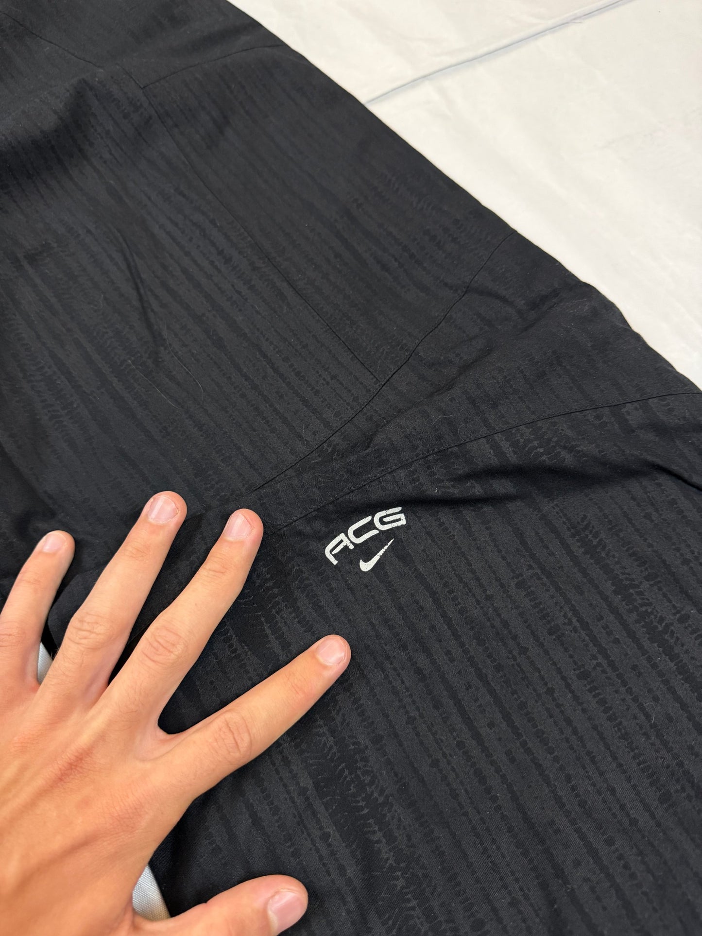 Nike black snow pants with ACG and Gore-Tex logos, adjustable waist, zippered vents.
