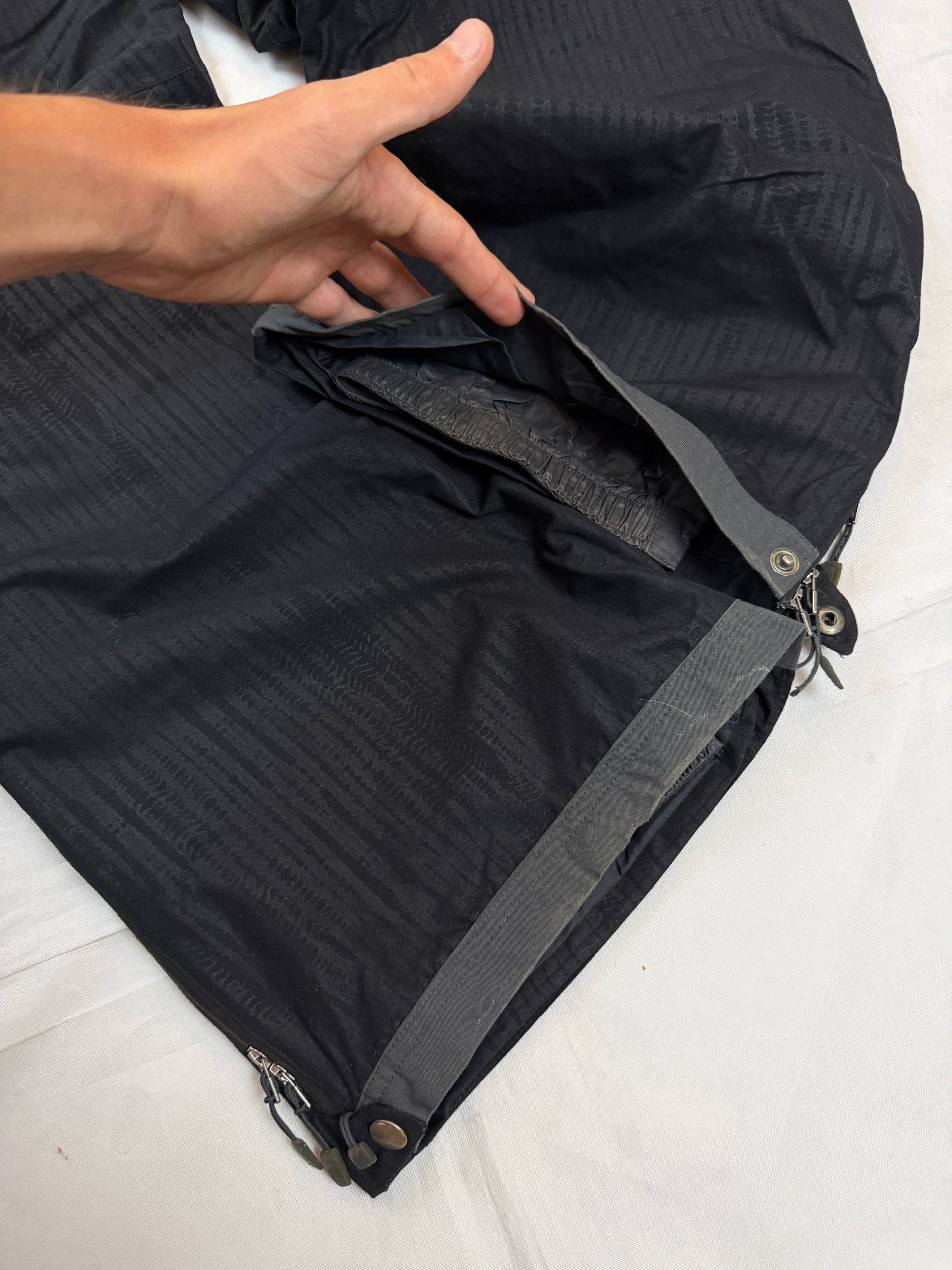 Nike black snow pants with ACG and Gore-Tex logos, adjustable waist, zippered vents.