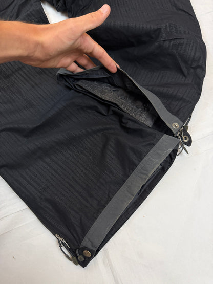 Nike black snow pants with ACG and Gore-Tex logos, adjustable waist, zippered vents.