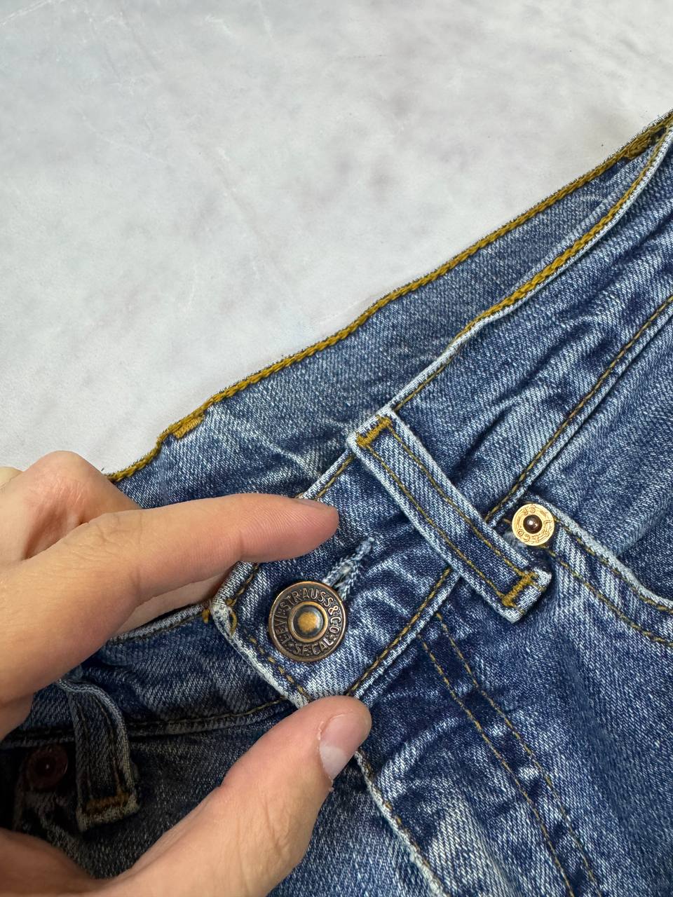 Levi's blue denim jeans with classic five-pocket design and iconic patch on waistband.