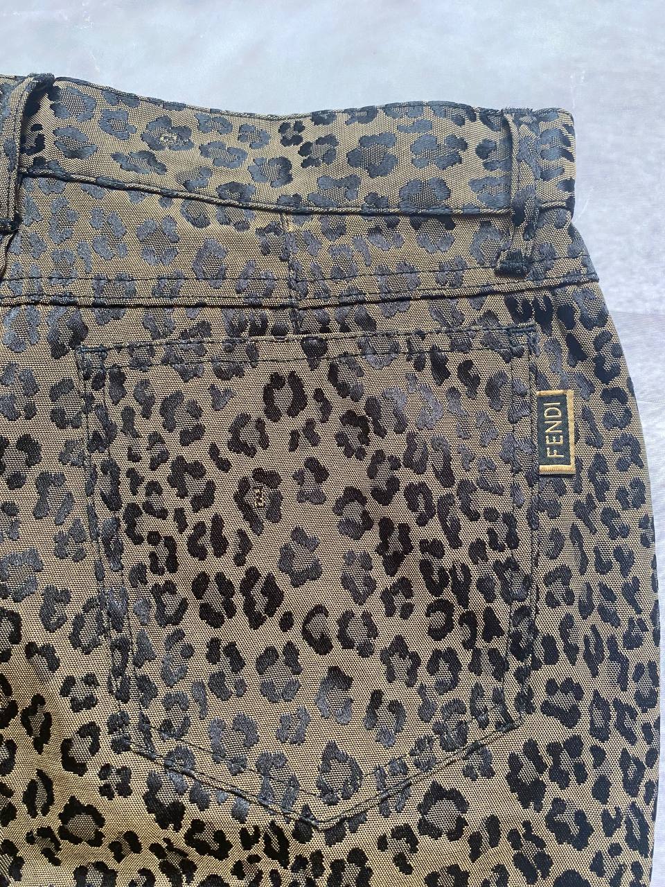 Iceberg brown leopard print trousers with front pockets and metal button closure.