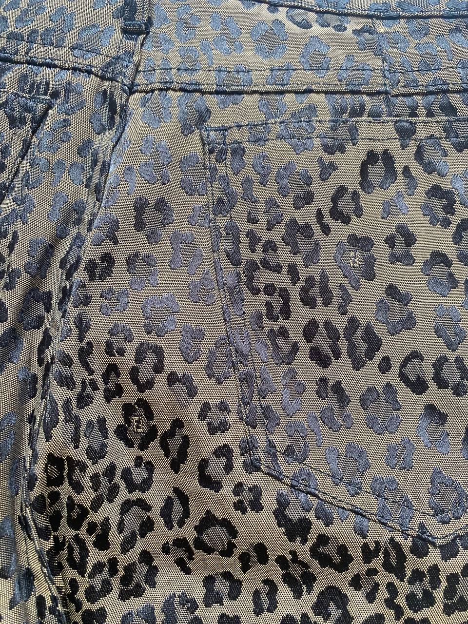 Iceberg brown leopard print trousers with front pockets and metal button closure.