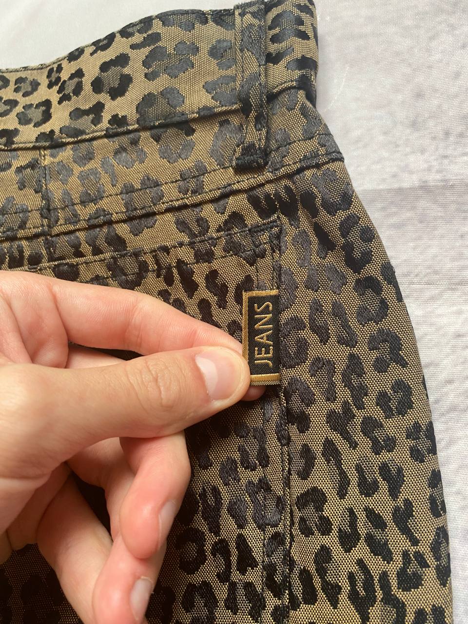 Iceberg brown leopard print trousers with front pockets and metal button closure.