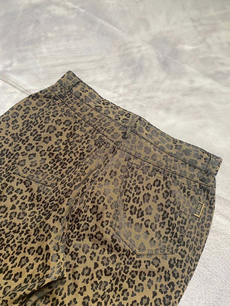 Iceberg brown leopard print trousers with front pockets and metal button closure.