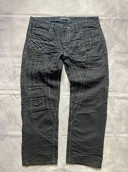 K&M black jeans size 38 with detailed white stitching and metallic stud accents.
