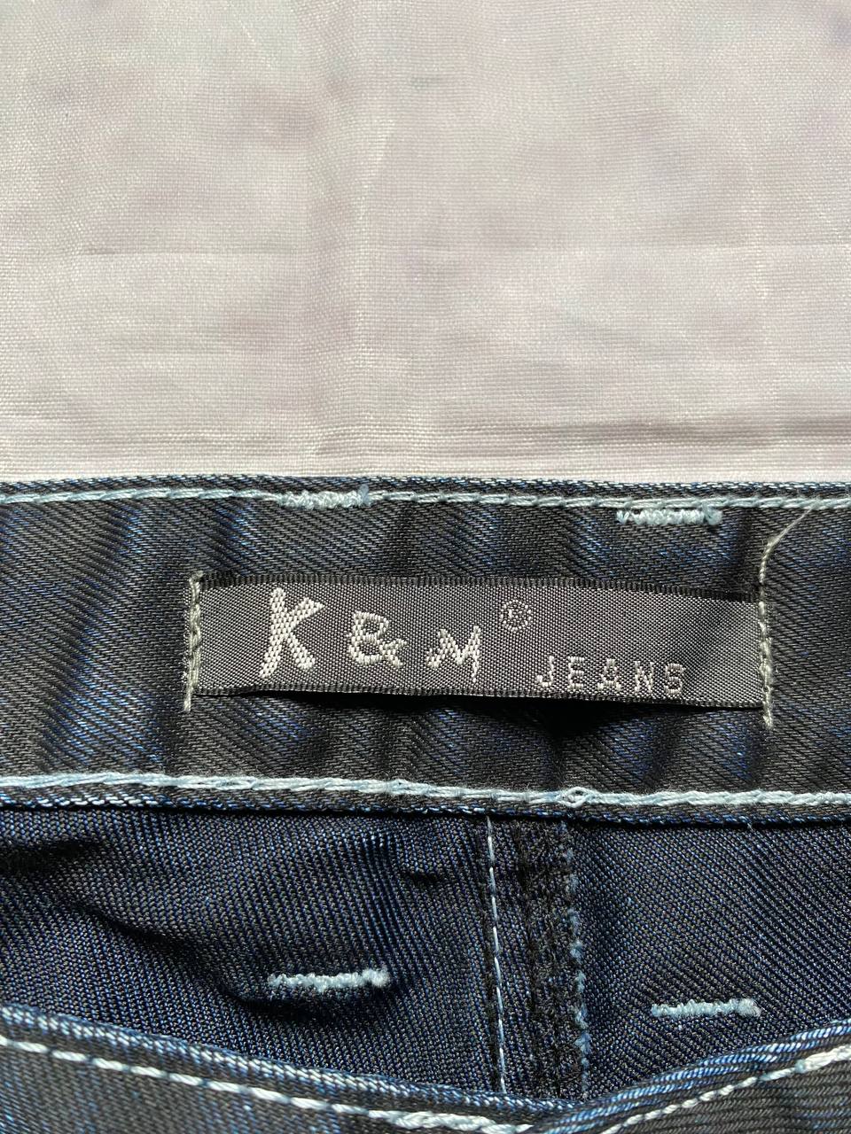 K&M black jeans size 38 with detailed white stitching and metallic stud accents.