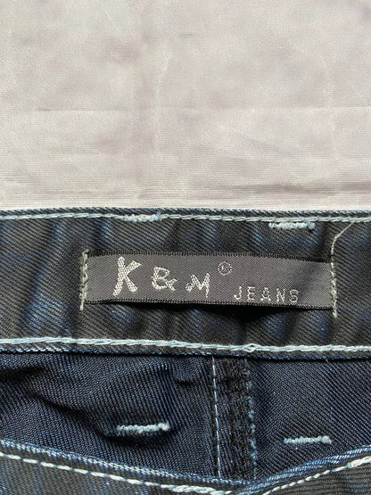 K&M black jeans size 38 with detailed white stitching and metallic stud accents.