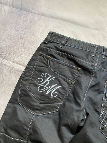 K&M black jeans size 38 with detailed white stitching and metallic stud accents.