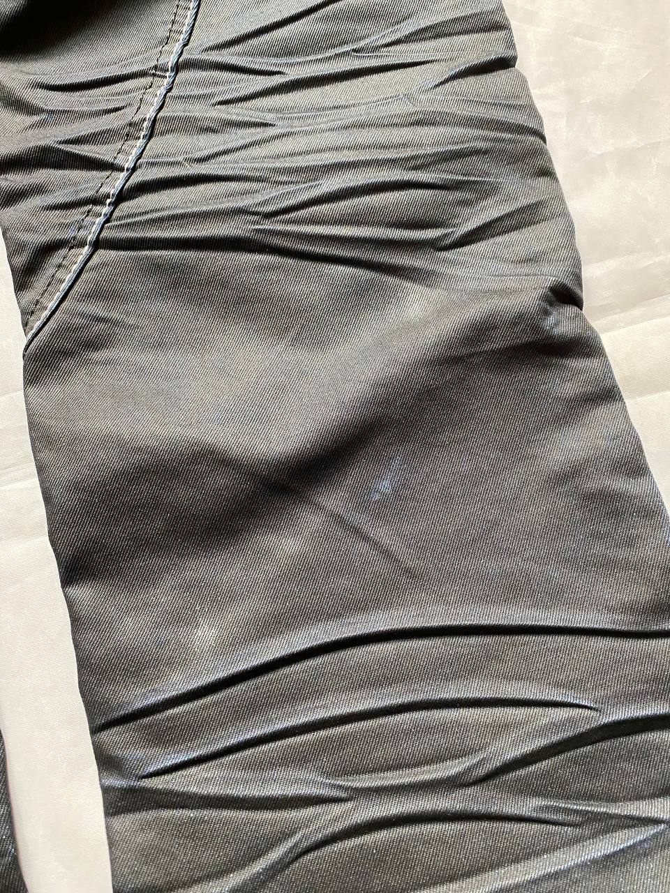 K&M black jeans size 38 with detailed white stitching and metallic stud accents.