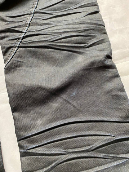 K&M black jeans size 38 with detailed white stitching and metallic stud accents.