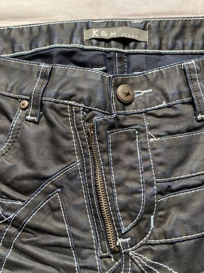 K&M black jeans size 38 with detailed white stitching and metallic stud accents.