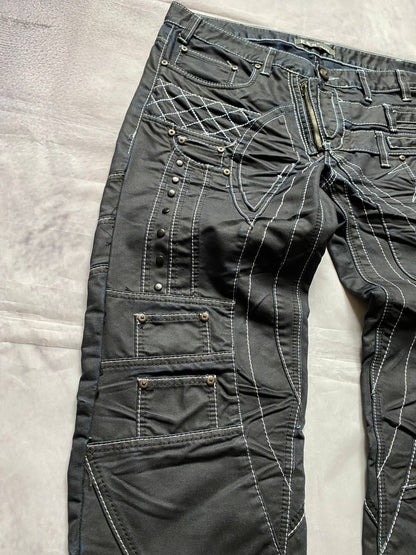 K&M black jeans size 38 with detailed white stitching and metallic stud accents.
