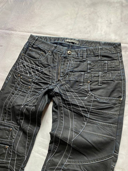 K&M black jeans size 38 with detailed white stitching and metallic stud accents.