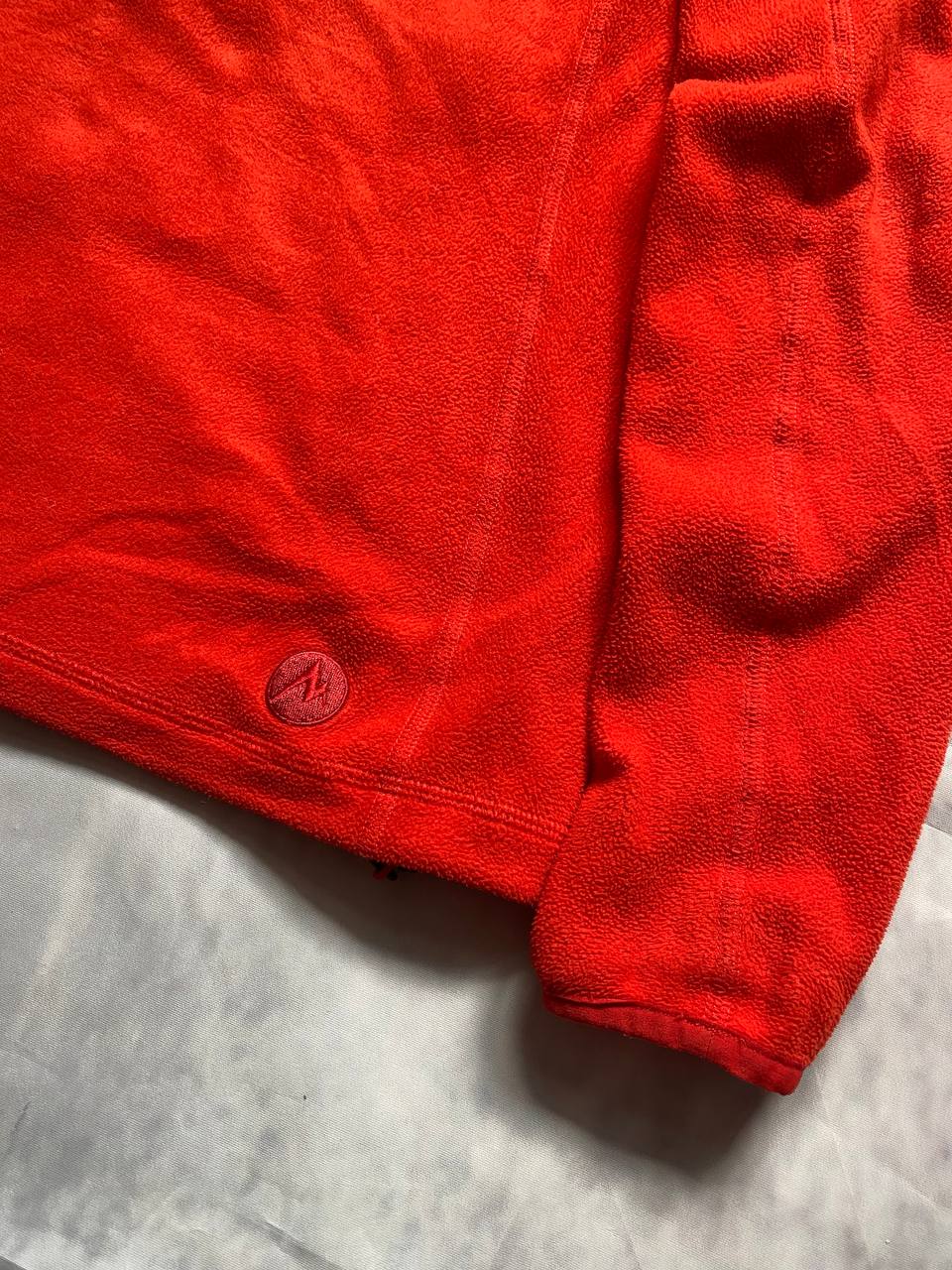 Marmot red fleece jacket with full zip, thumb holes, and elbow patch detail.