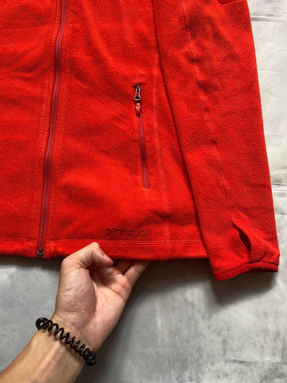 Marmot red fleece jacket with full zip, thumb holes, and elbow patch detail.