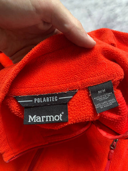 Marmot red fleece jacket with full zip, thumb holes, and elbow patch detail.