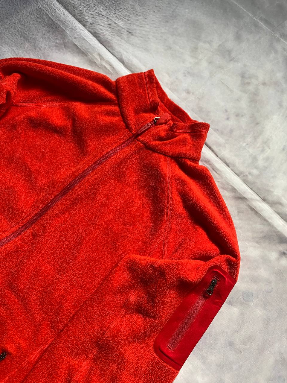 Marmot red fleece jacket with full zip, thumb holes, and elbow patch detail.