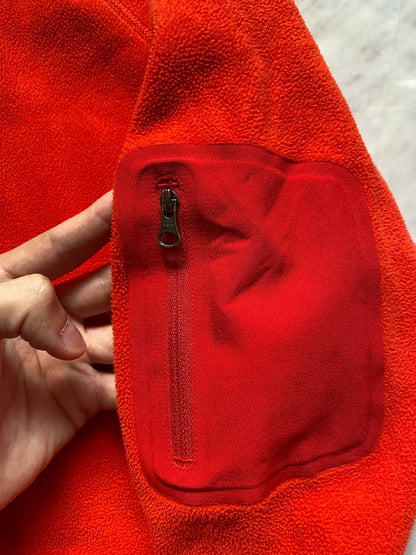 Marmot red fleece jacket with full zip, thumb holes, and elbow patch detail.
