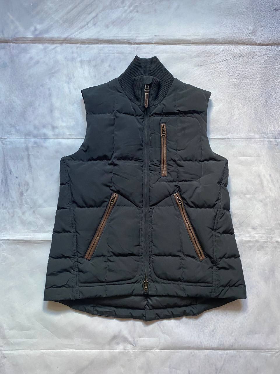 Ralph Lauren black puffer gilet vest with brown zippered pockets and ribbed neck.