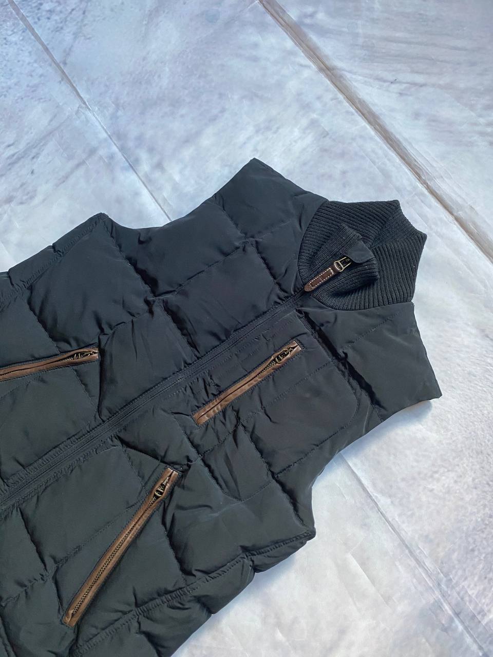 Ralph Lauren black puffer gilet vest with brown zippered pockets and ribbed neck.