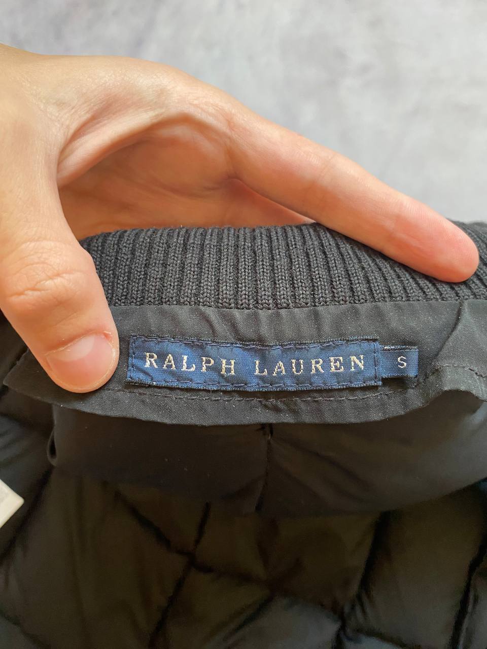 Ralph Lauren black puffer gilet vest with brown zippered pockets and ribbed neck.