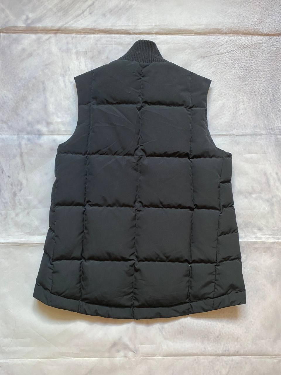 Ralph Lauren black puffer gilet vest with brown zippered pockets and ribbed neck.