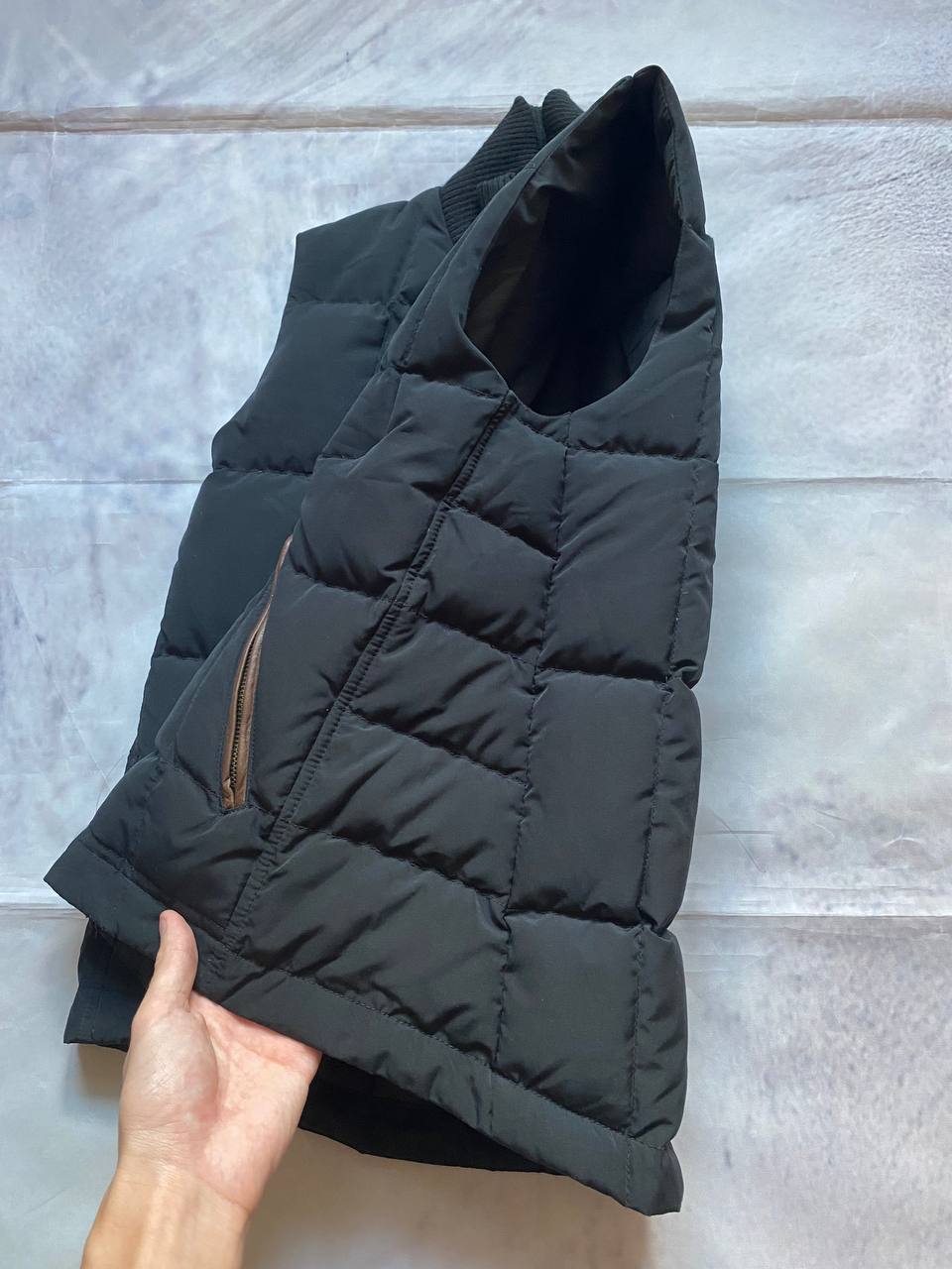Ralph Lauren black puffer gilet vest with brown zippered pockets and ribbed neck.