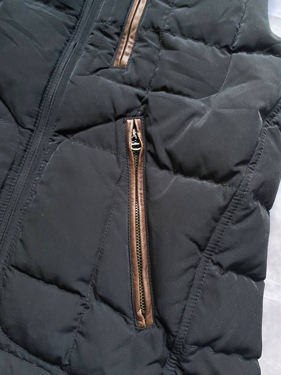 Ralph Lauren black puffer gilet vest with brown zippered pockets and ribbed neck.