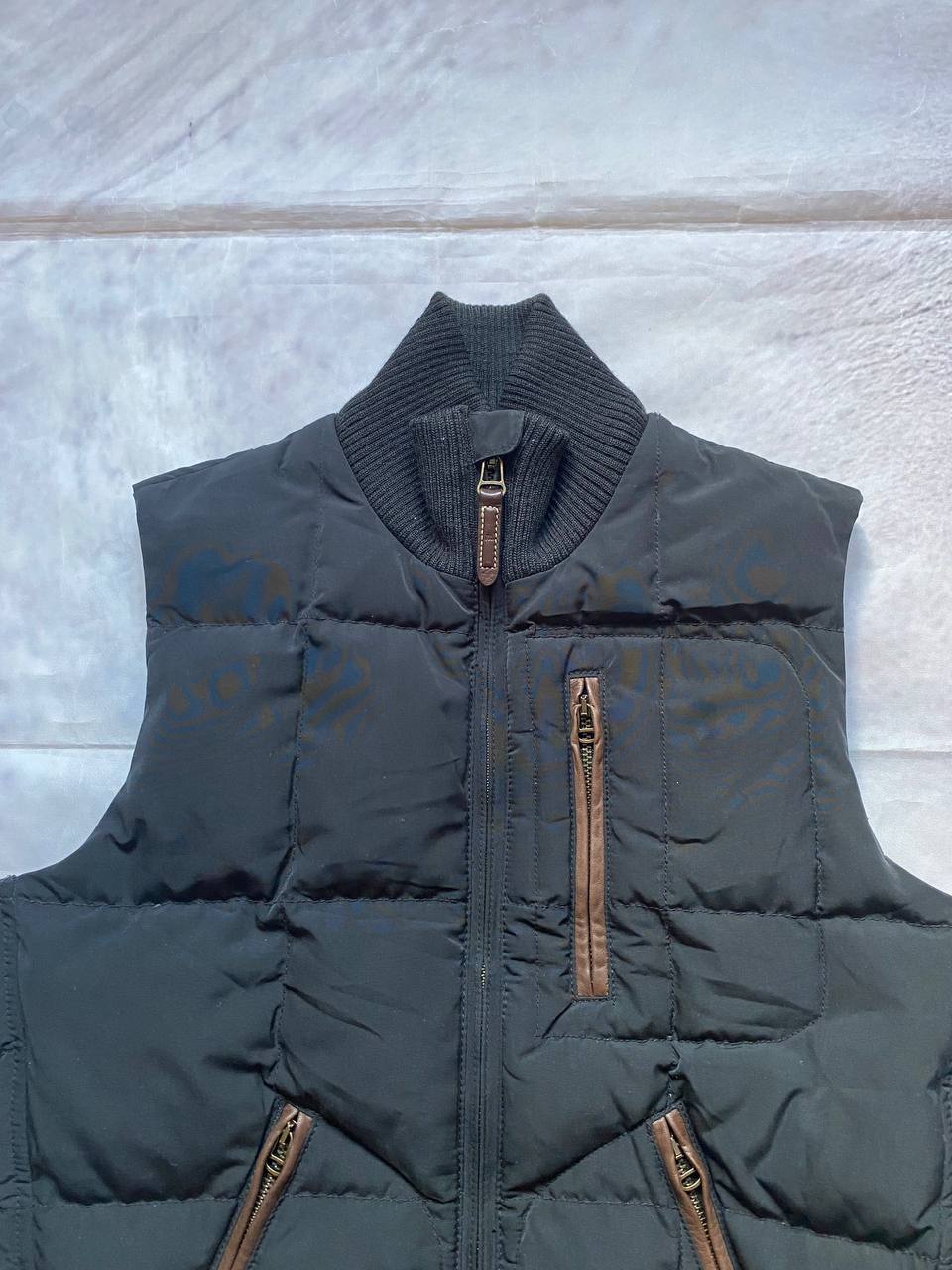 Ralph Lauren black puffer gilet vest with brown zippered pockets and ribbed neck.