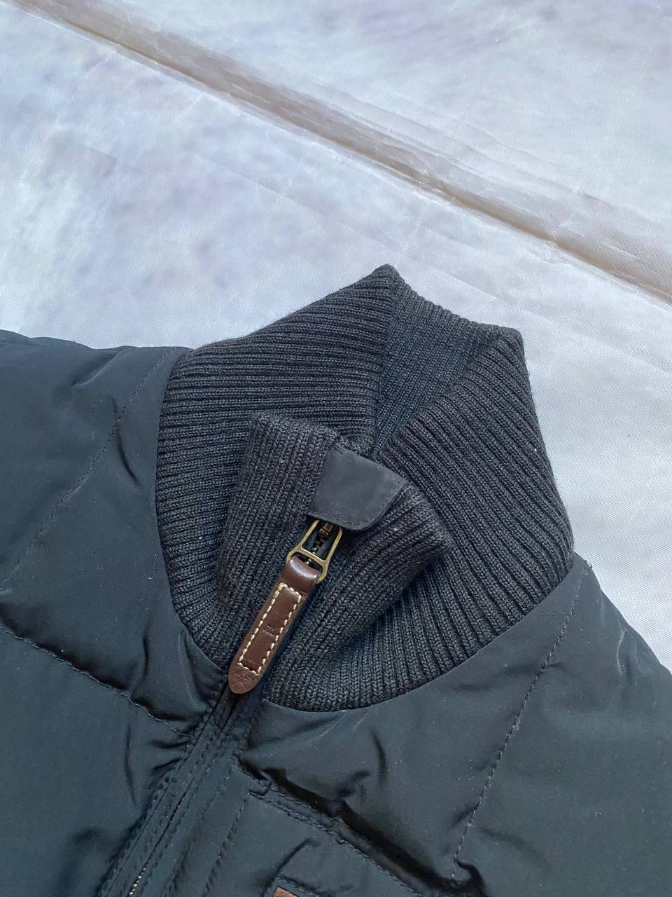 Ralph Lauren black puffer gilet vest with brown zippered pockets and ribbed neck.