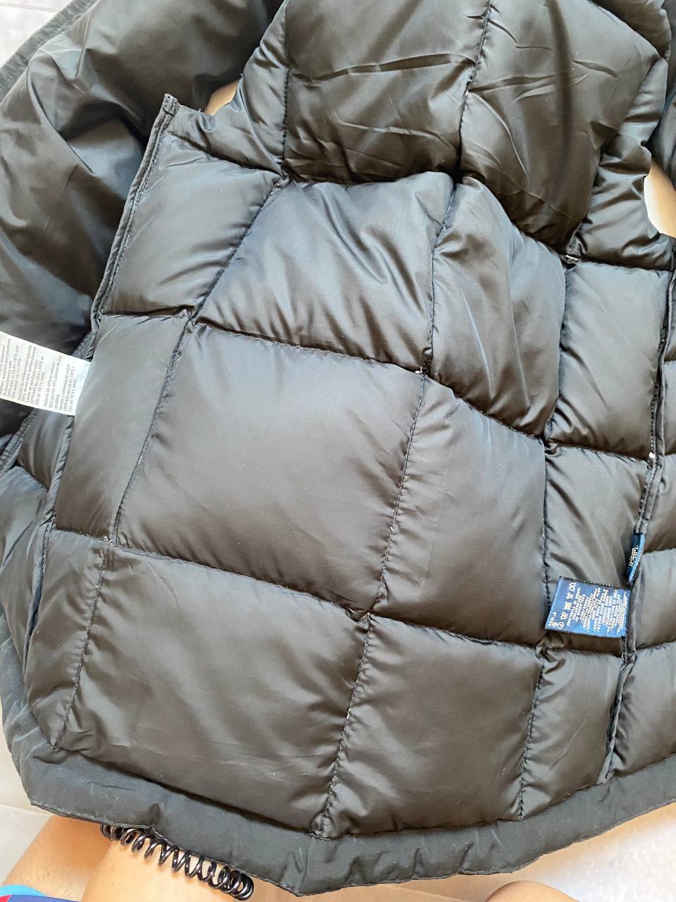 Ralph Lauren black puffer gilet vest with brown zippered pockets and ribbed neck.
