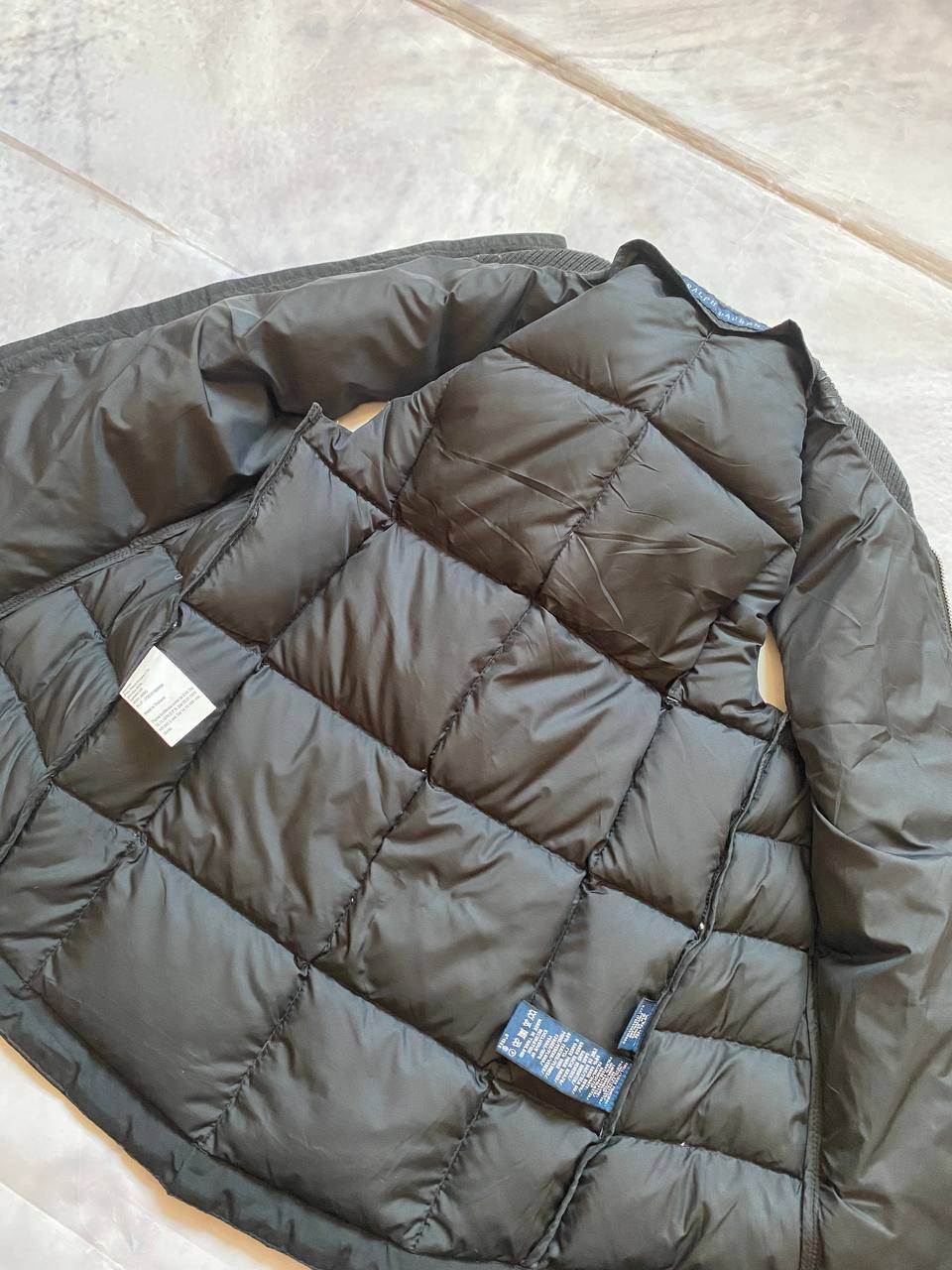 Ralph Lauren black puffer gilet vest with brown zippered pockets and ribbed neck.