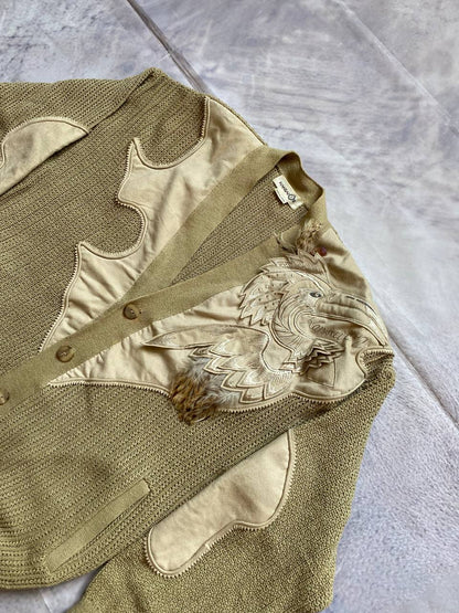 Kansai O2 beige knitted cardigan with embroidered bird detail and fabric patches.