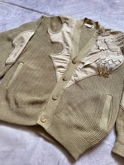 Kansai O2 beige knitted cardigan with embroidered bird detail and fabric patches.