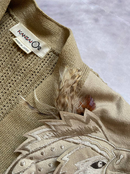 Kansai O2 beige knitted cardigan with embroidered bird detail and fabric patches.
