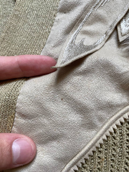 Kansai O2 beige knitted cardigan with embroidered bird detail and fabric patches.