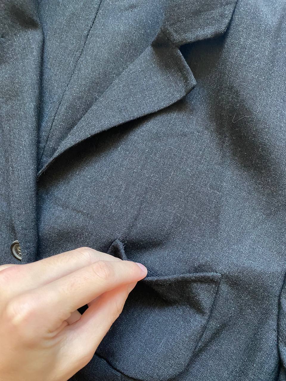 Beams black cotton linen blazer with padded shoulders, three-button front, and slit cuff detail.
