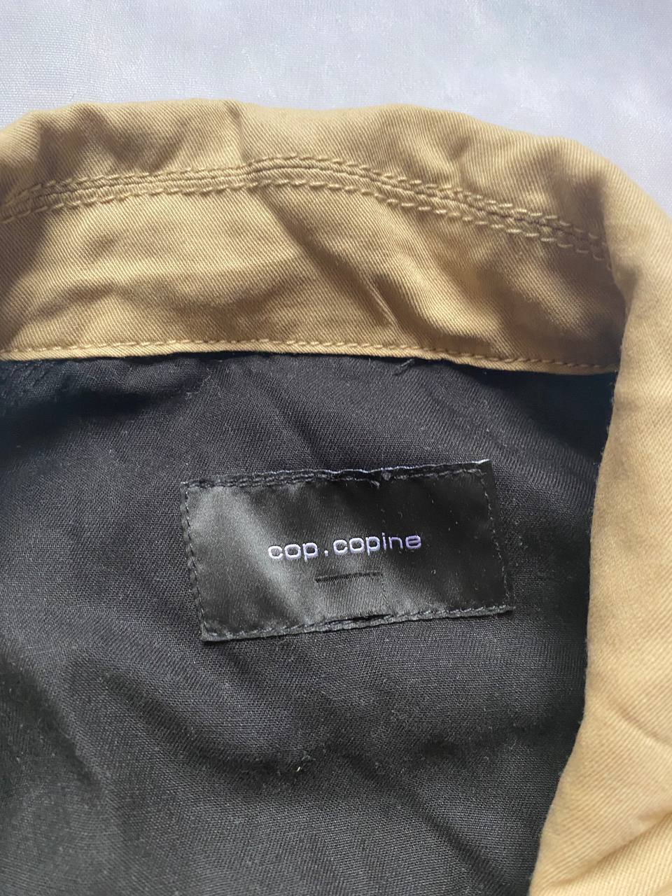 Cop.Copine beige and black trench coat, 100% Lyocell, button closures, adjustable sleeve straps.