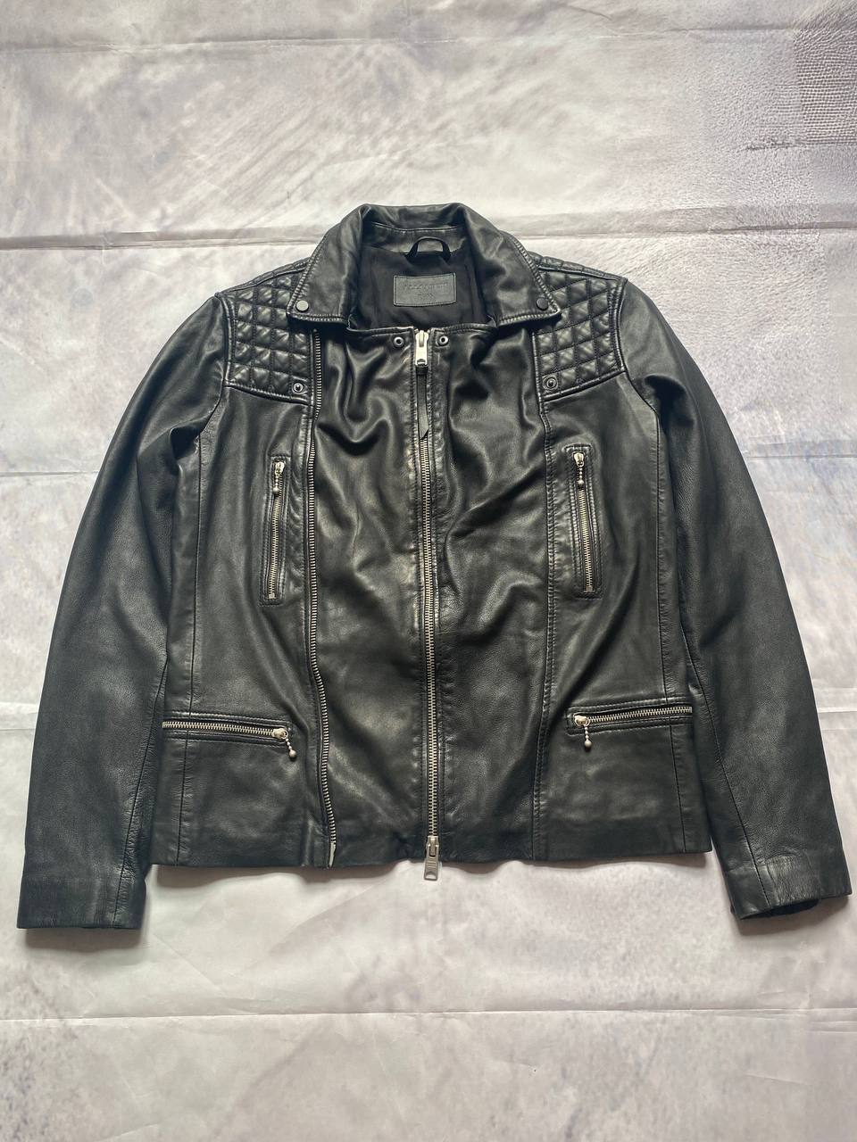 All Saints black quilted leather biker jacket with zippered pockets and adjustable cuffs.
