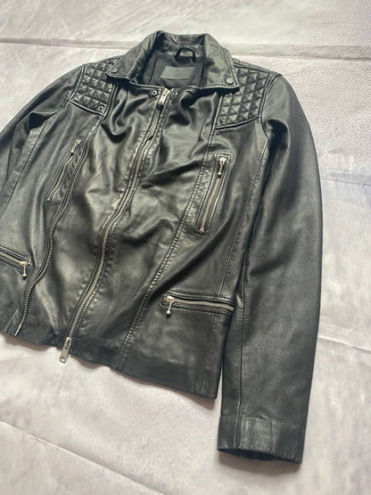 All Saints black quilted leather biker jacket with zippered pockets and adjustable cuffs.