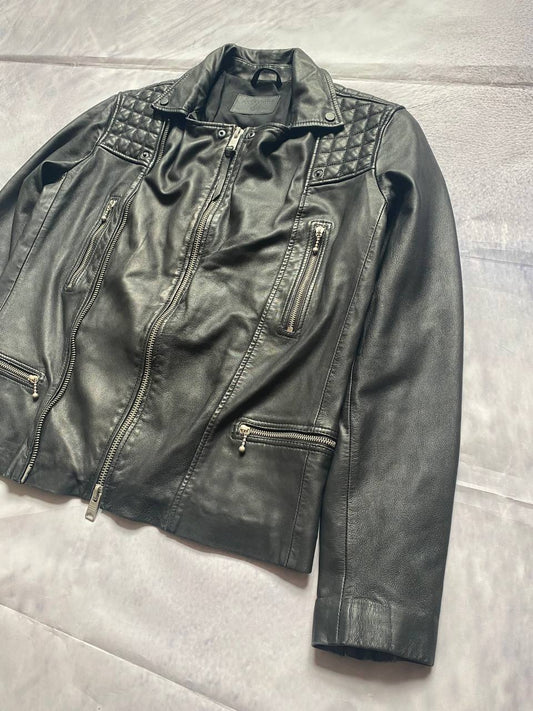 All Saints black quilted leather biker jacket with zippered pockets and adjustable cuffs.