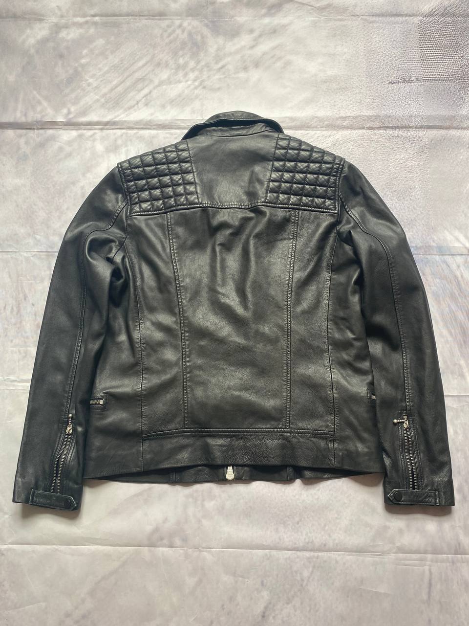 All Saints black quilted leather biker jacket with zippered pockets and adjustable cuffs.