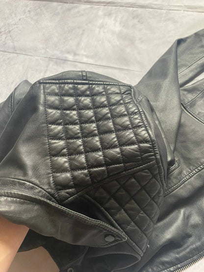 All Saints black quilted leather biker jacket with zippered pockets and adjustable cuffs.