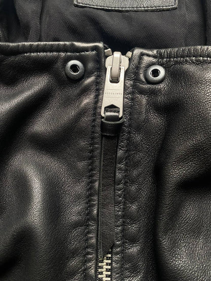 All Saints black quilted leather biker jacket with zippered pockets and adjustable cuffs.