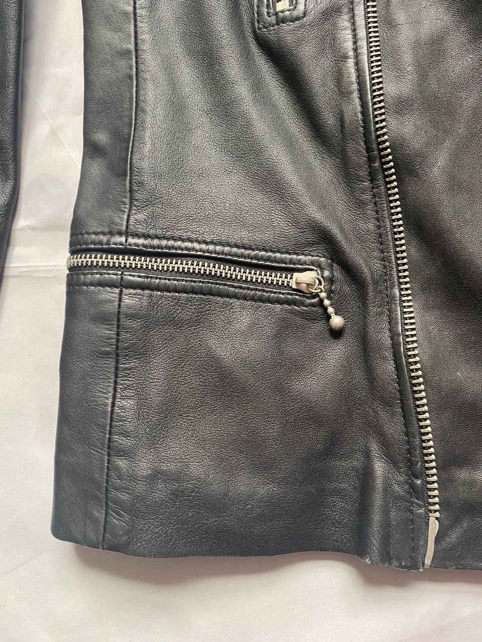 All Saints black quilted leather biker jacket with zippered pockets and adjustable cuffs.