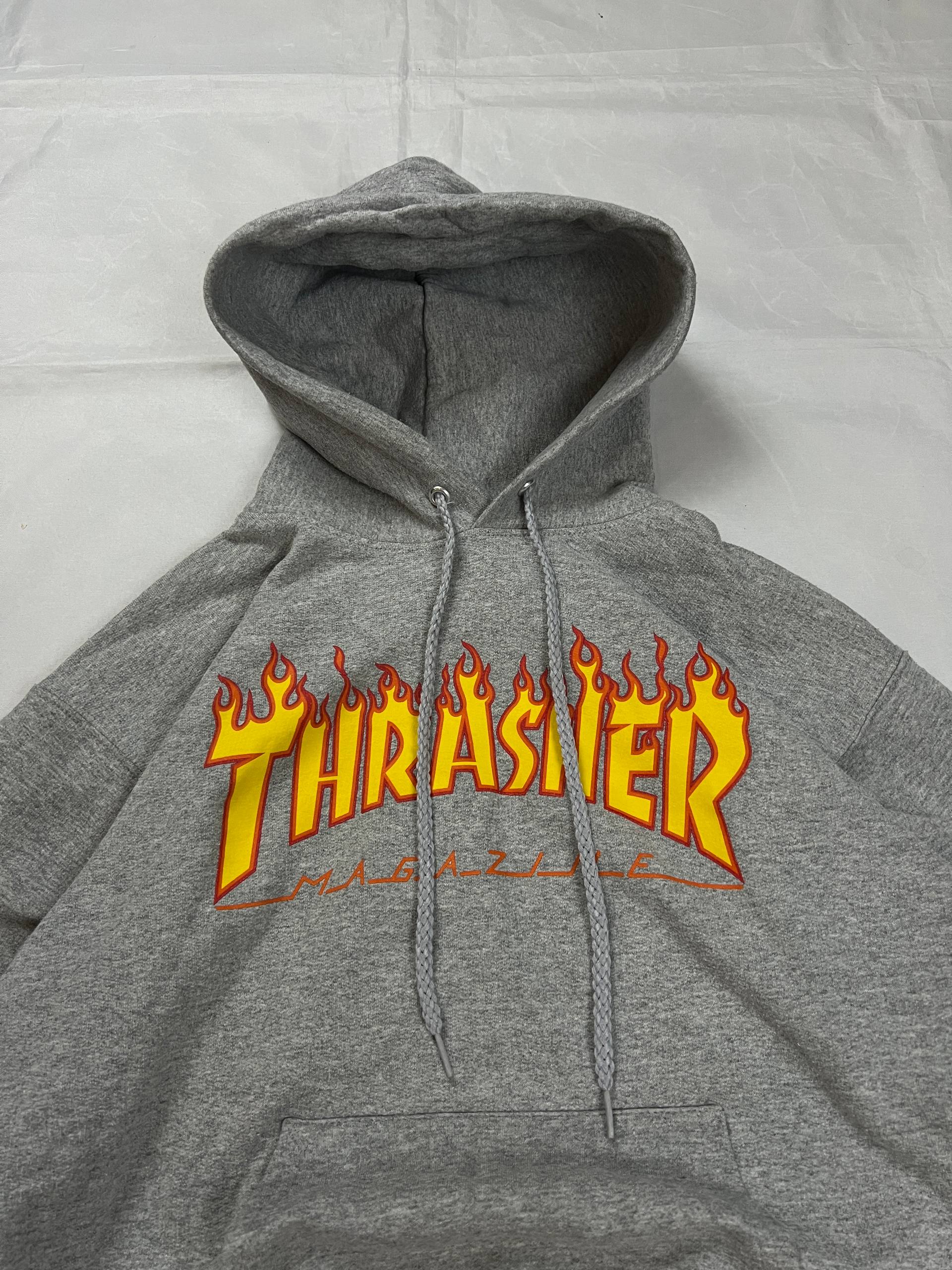 Thrasher grey hoodie with yellow and red flaming logo, kangaroo pocket, drawstring hood.